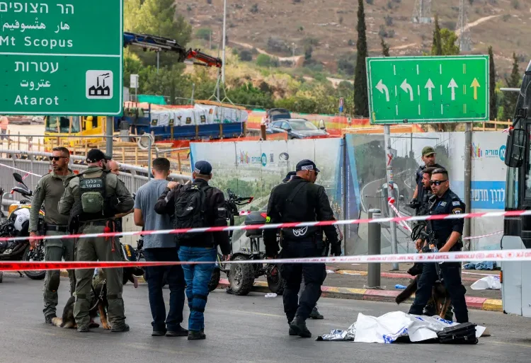 Six People Killed In Jerusalem Shooting Attack 1 Israeli forces gather by a body next to a bus at Ramot Junction in occupied East Jerusalem on September 8, 2025.