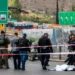 Israeli forces gather by a body next to a bus at Ramot Junction in occupied East Jerusalem on September 8, 2025.