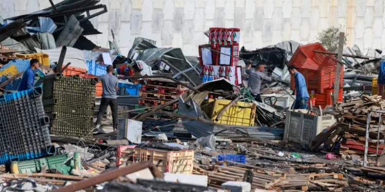 Palestinian vendors salvage items from the rubble after the Israeli army demolished 16 shops at the produce market in Beita village, south of Nablus in the occupied West Bank.
