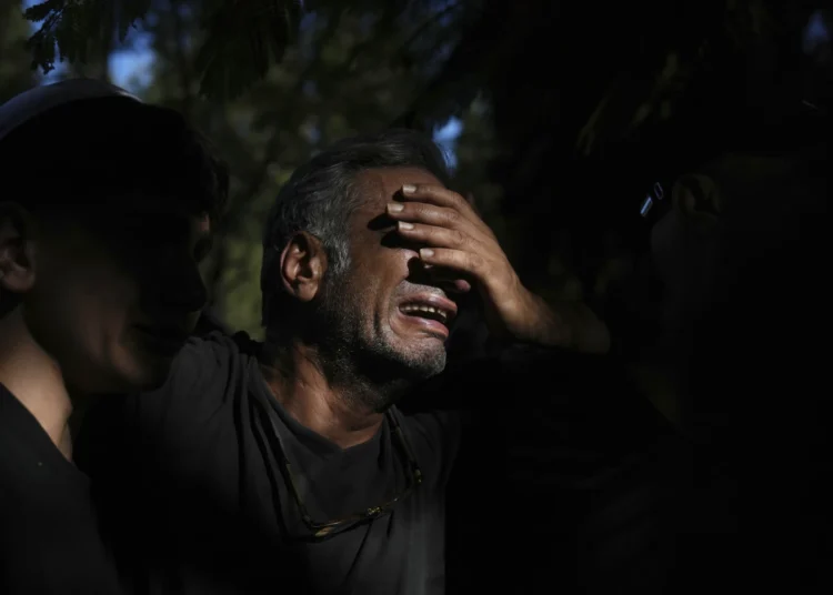 A relative mourns during the funeral of slain hostage Idan Shtivi, whose body was recovered in an Israeli military operation in the Gaza Strip, in Kfar Maas, Israel, Monday, Sept. 1, 2025.