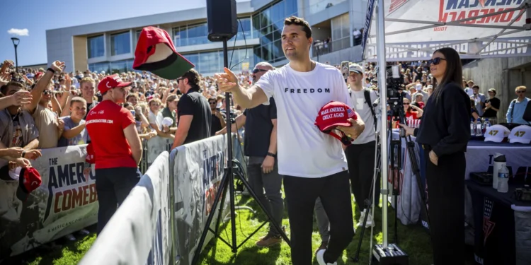 Charlie Kirk hands out hats before speaking at Utah Valley University in Orem, Utah, Wednesday, Sept. 10, 2025.