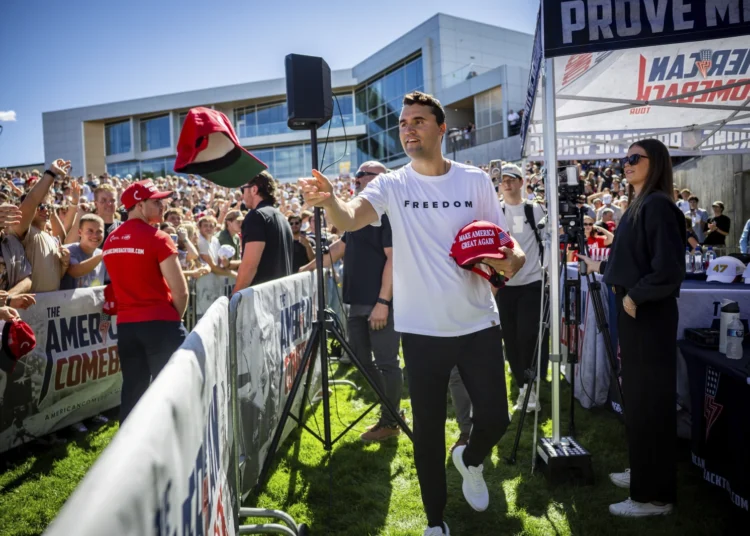 Charlie Kirk hands out hats before speaking at Utah Valley University in Orem, Utah, Wednesday, Sept. 10, 2025.