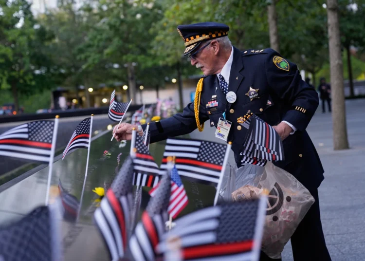 US Marks 24th Anniversary Of 9/11 Attacks 1 Sam Pulia places flags on names inscribed in the 9/11 Memorial before the start of a ceremony commemorating the 24th anniversary of the Sept. 11, 2001, attacks, Thursday, Sept. 11, 2025, in New York.