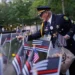Sam Pulia places flags on names inscribed in the 9/11 Memorial before the start of a ceremony commemorating the 24th anniversary of the Sept. 11, 2001, attacks, Thursday, Sept. 11, 2025, in New York.