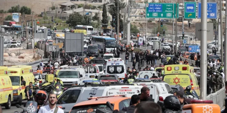Israeli Ministers Call For Deportations Of Families Of Palestinian Attackers 1 Israeli forces gather by a body next to a bus at Ramot Junction in occupied East Jerusalem on September 8, 2025.