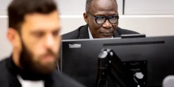 Ali Muhammad Ali Abd-Al-Rahman, also known as Ali Kushayb, right, attends a hearing in his trial at the International Criminal Court in The Hague in October 2023.