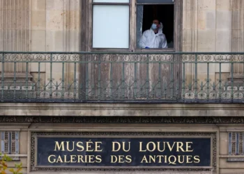 A member of a forensic team inspects a window believed to have been used in a robbery at the Louvre Museum in Paris, France, on October 19, 2025.