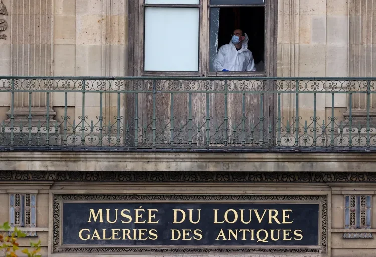Five New Suspects Arrested Over Louvre Heist 1 A member of a forensic team inspects a window believed to have been used in a robbery at the Louvre Museum in Paris, France, on October 19, 2025.