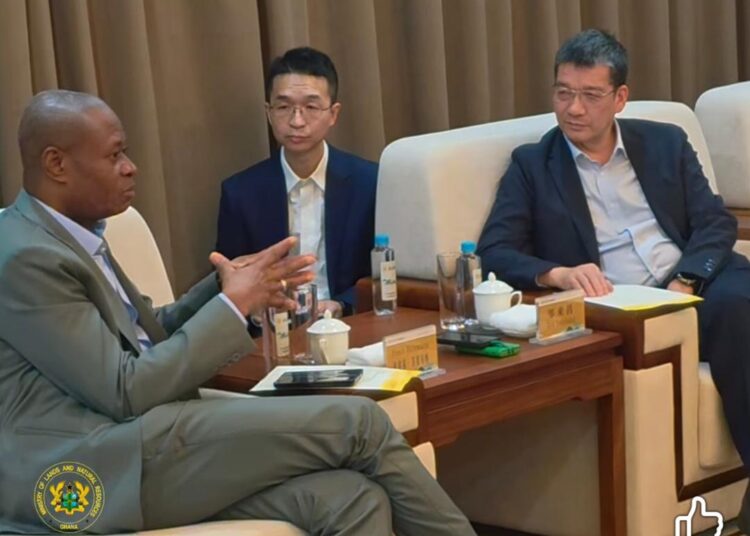 Deputy Lands Minister with Zinjin Staff