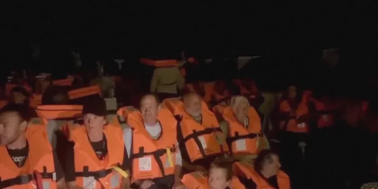 Crew of Conscience, a Gaza-bound vessel, sit on board the boat as they are intercepted by Israeli security forces, in this screengrab obtained from a video.