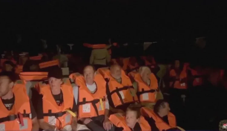 Another Gaza Aid Flotilla Intercepted 1 Crew of Conscience, a Gaza-bound vessel, sit on board the boat as they are intercepted by Israeli security forces, in this screengrab obtained from a video.
