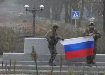 Putin Celebrates Claimed Capture of Pokrovsk 6 A soldier holds a Russian flag in Pokrovsk