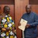 Asantehene Otumfuo Osei Tutu II (L) handing over the Mediation Report to President John Dramani Mahama (R)