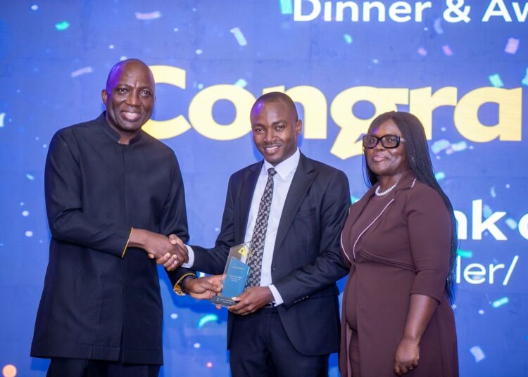 Fintech Innovators and Service Providers Celebrated at MobileMoney LTD Stakeholder Dinner and Awards 1 CEO of MobileMoney LTD presenting the award for Regulator of the Year to the Bank of Ghana