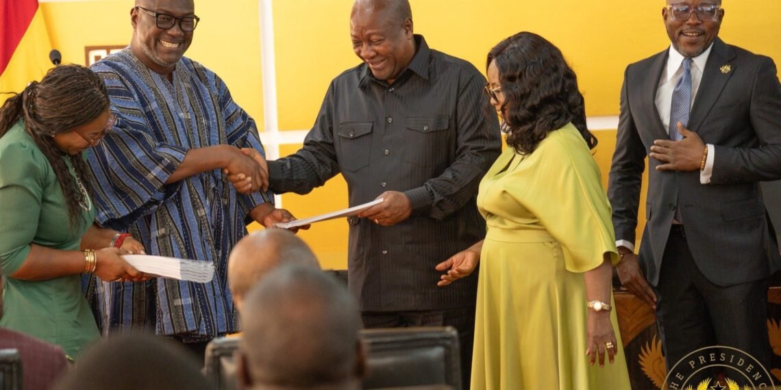 President John Dramani Mahama receiving a summary of the CRC's report from its Chairman Professor H. Kwasi Prempeh