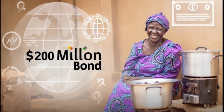 Global Investors Back $200m Bond for Cleaner Cooking Access in Ghana 1 A smiling Ghanaian woman in vibrant purple traditional attire sits proudly beside a modern clean cookstove with a large silver pot.