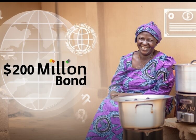 Global Investors Back $200m Bond for Cleaner Cooking Access in Ghana 1 A smiling Ghanaian woman in vibrant purple traditional attire sits proudly beside a modern clean cookstove with a large silver pot.