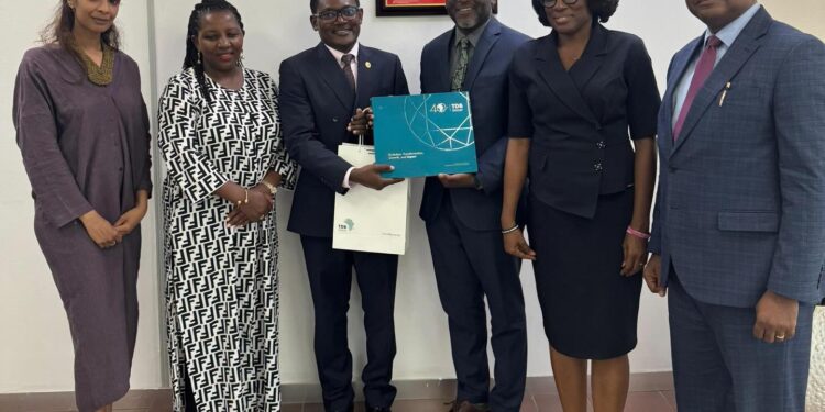 Tom Mzumara, Group Corporate Secretary, with Mr. Nana Dwemoh Benneh, CEO of GIIF, and Representatives
