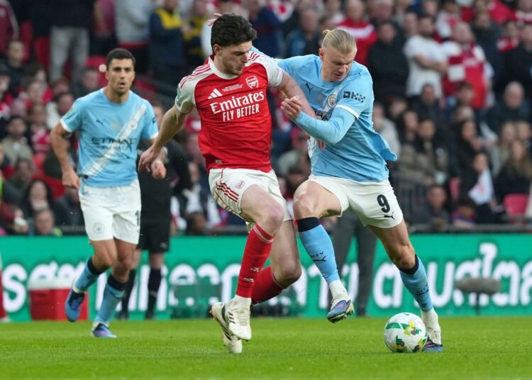 Manchester City Close In on Arsenal After Crucial win 1 Declan Rice (Arsenal) and Erling Haaland (Manchester City) in a tussel for the ball