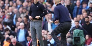 Mikel Arteta watches Pep Guardiola from his technical area at the Etihad stadium