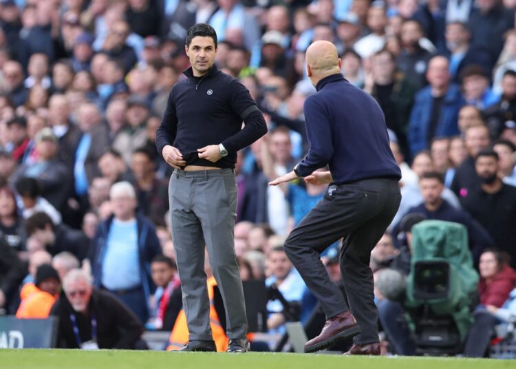 Arteta Refuses to Give Up on PL Title Ambition 1 Mikel Arteta watches Pep Guardiola from his technical area at the Etihad stadium