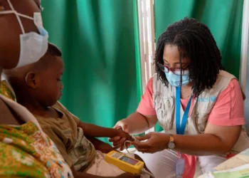 A child receiving pneumonia treatment from a medical professional