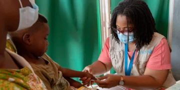 A child receiving pneumonia treatment from a medical professional