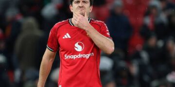 Harry Maguire holds in chin after going for a tackle