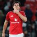 Harry Maguire holds in chin after going for a tackle