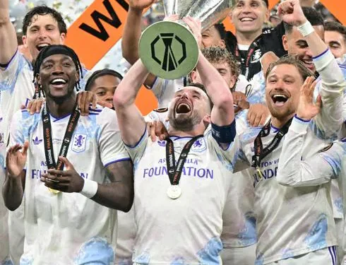 Aston Villa captain John Mcginn lifts the Uefa Europa League trophy