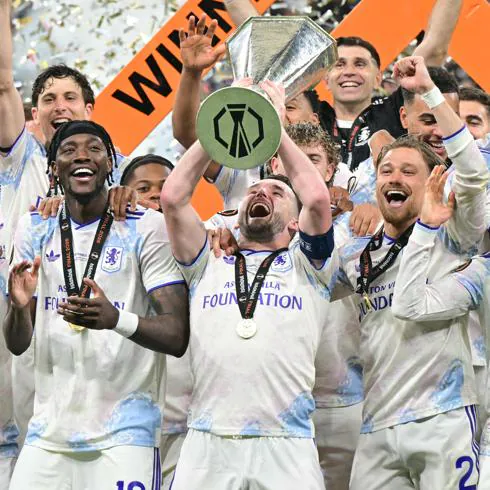 Aston Villa captain John Mcginn lifts the Uefa Europa League trophy