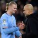 Erling Haaland (blue) shakes his manager Pep Guardiola (black)