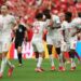 Canada players celebrating after making knockout round of the FIFA World Cup for the first time in their history