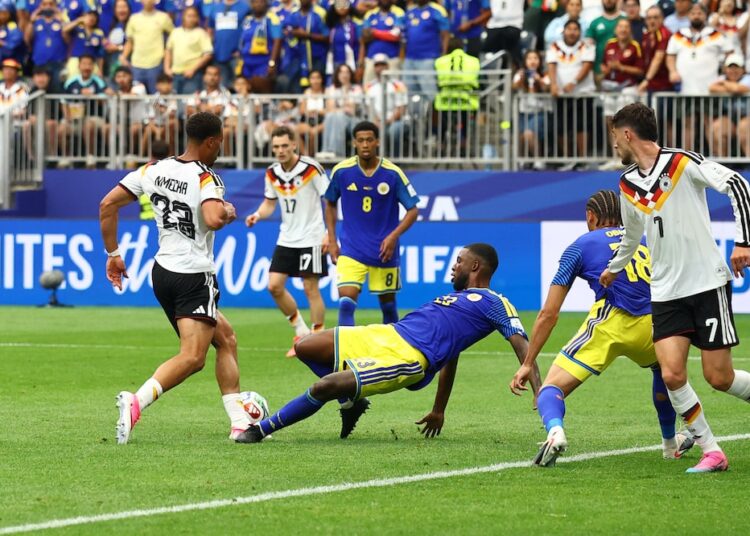 Felix Nmecha goes down in the box after a challenge from the Curaçao defender