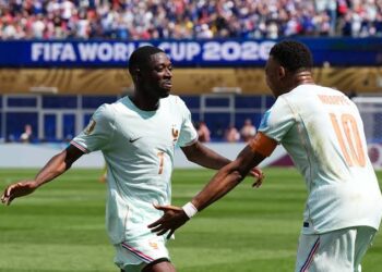 Ousmane Dembele and Kylian Mbappé celebrating after scoring against Morocco