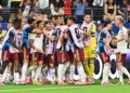Spain's reserve players run onto the pitch to celebrate after scoring against France in Dallas
