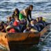 Migrants on a makeshift vessel traversing the sea