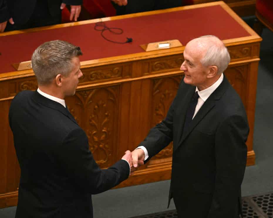 Hungary Elects New President 3 Hungary’s newly elected President András Baka shakes hands with Hungarian Prime Minister Péter Magyar after he was elected at the parliament in Budapest.