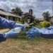 Health worker in personal protective equipment (PPE) undertaking sanitation measures