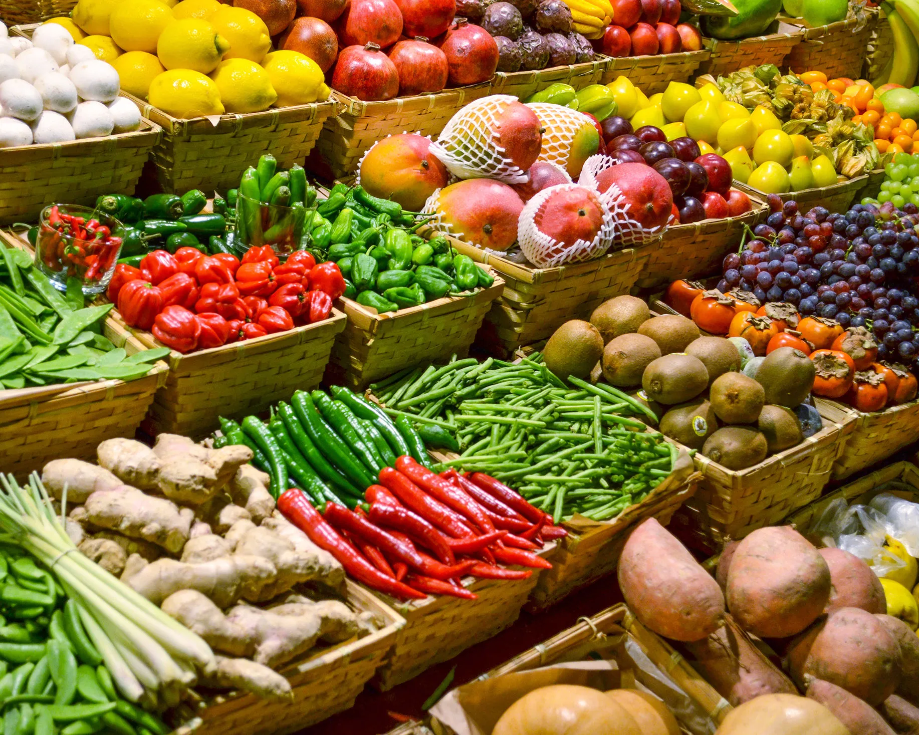 A vibrant display of fresh produce at an open-air market stall