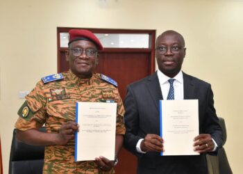 Ghana, Burkina Faso Sign Defence Pact To Secure Trade Corridors 4 Major General Célestin Simporé and Dr Cassiel Ato Baah Forson hold up the French and English texts of the Technical Arrangement on escort and security support for military equipment and convoys