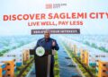 President Mahama speaks beneath a rendering of the completed estate, part of a "Live Well, Pay Less" campaign inviting Ghanaians to register interest in the revived Saglemi Housing Project.