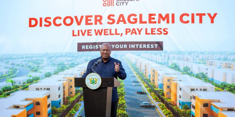 Saglemi Housing Revival: 700 Units Ready by March, 1,500 by December 2027 1 President Mahama speaks beneath a rendering of the completed estate, part of a "Live Well, Pay Less" campaign inviting Ghanaians to register interest in the revived Saglemi Housing Project.