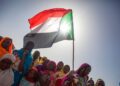UN Warns Sudan War’s Consequences Will Be Long-Lasting 7 Sudanese women wave the national flag during a pro-democracy rally