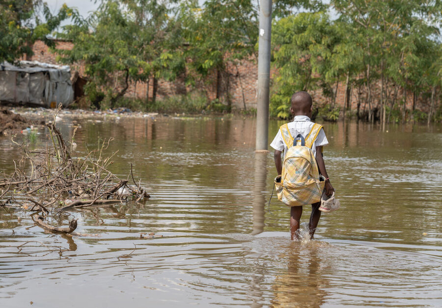 El Niño Could Push 49 Million More People Into Hunger, WFP Warns 3 a child wading through floodwaters