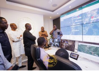 Dr. Sylvester Akpah explaining the new technology to the minister of lands
