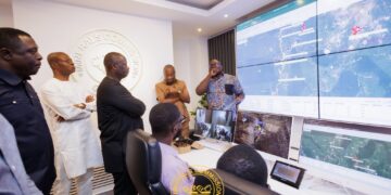 Dr. Sylvester Akpah explaining the new technology to the minister of lands