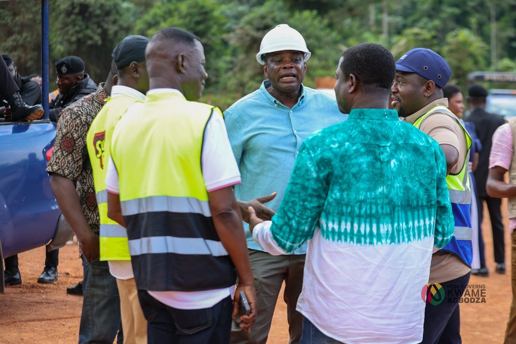 Roads and Highways Minister Kwame Governs Agbodza and Deputy Minister Alhassan Suhuyini hold on-site talks with contractors and officials to assess progress on Big Push roads in the Western North Region.