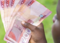 Secured Credit Jumps 73% Despite Fewer Registrations 6 A Ghanaian holding notes