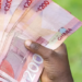 Secured Credit Jumps 73% Despite Fewer Registrations 11 A Ghanaian holding notes